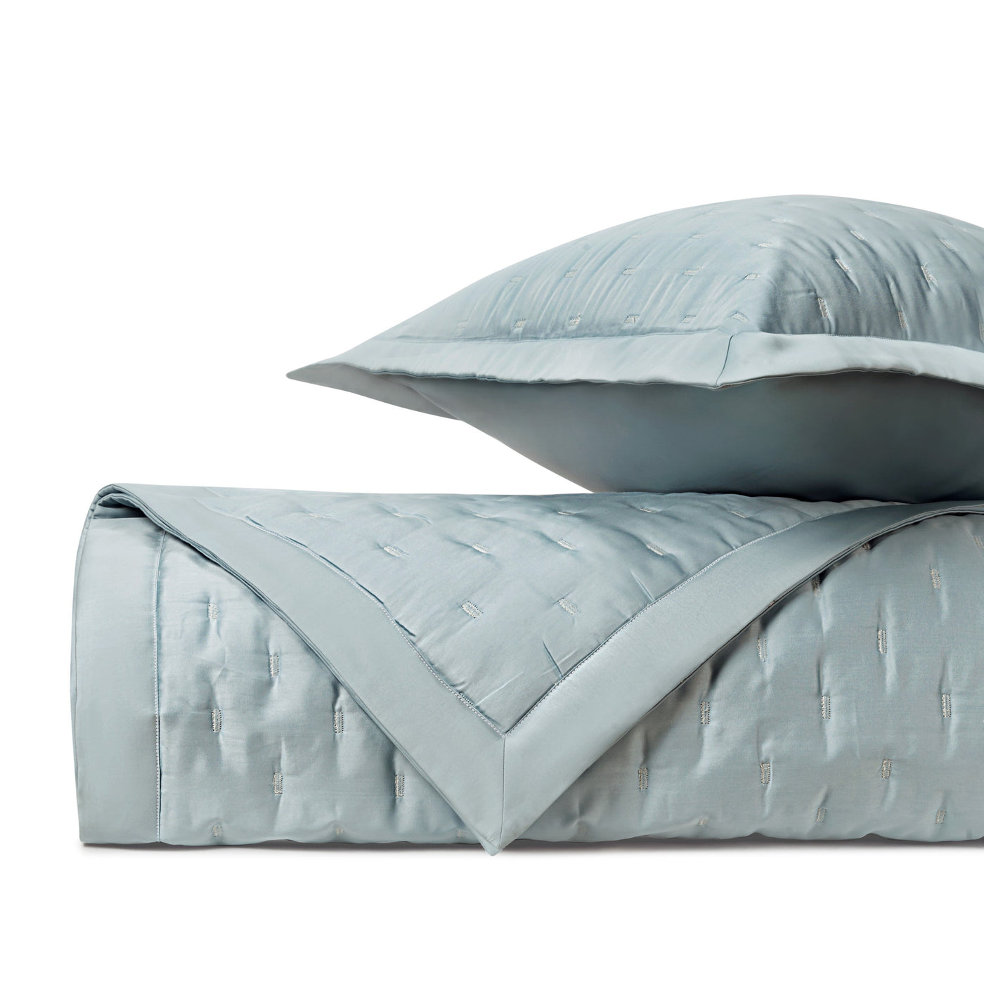 Close-up of Home Treasures Fil Coupé quilted coverlet in mist blue with textured clipped pattern.