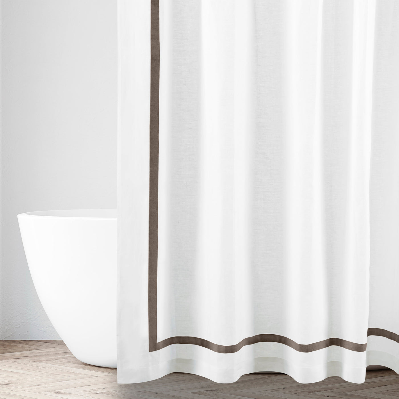 White cotton shower curtain with mocha border trim, styled in a bright bathroom setting.