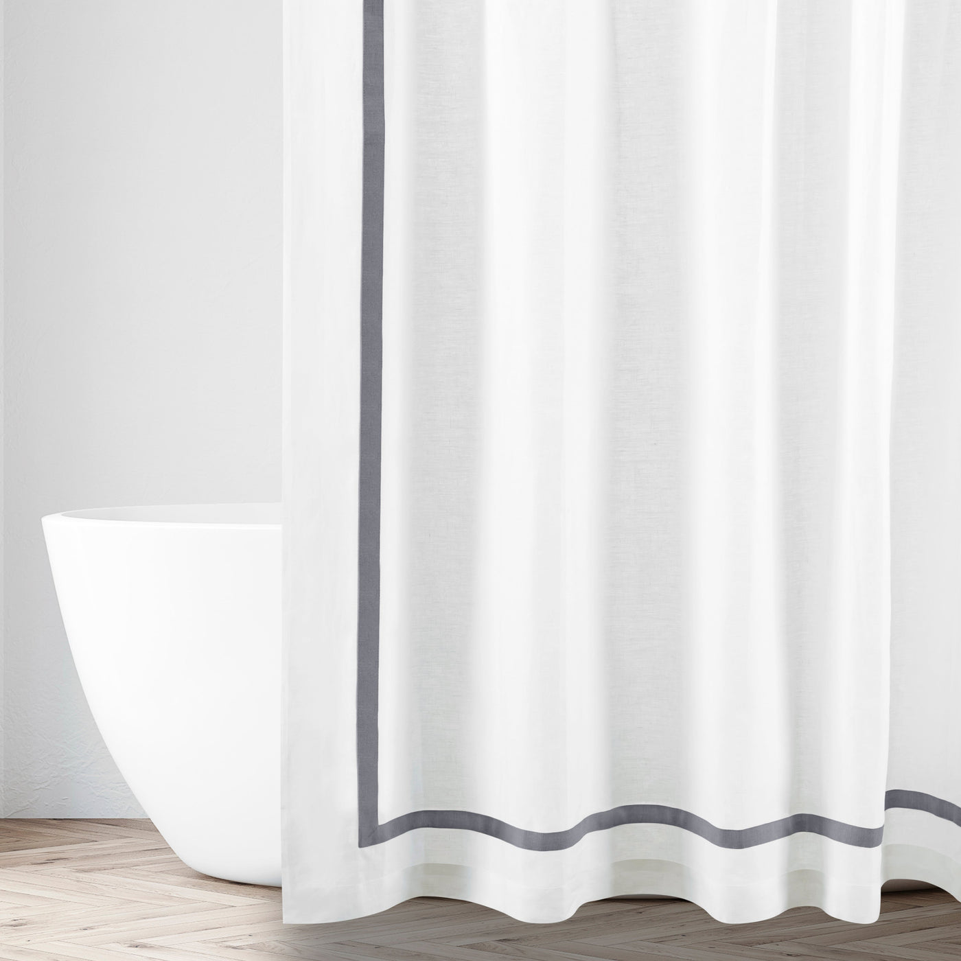 White shower curtain with slate grey border trim, styled in a bright bathroom setting.
