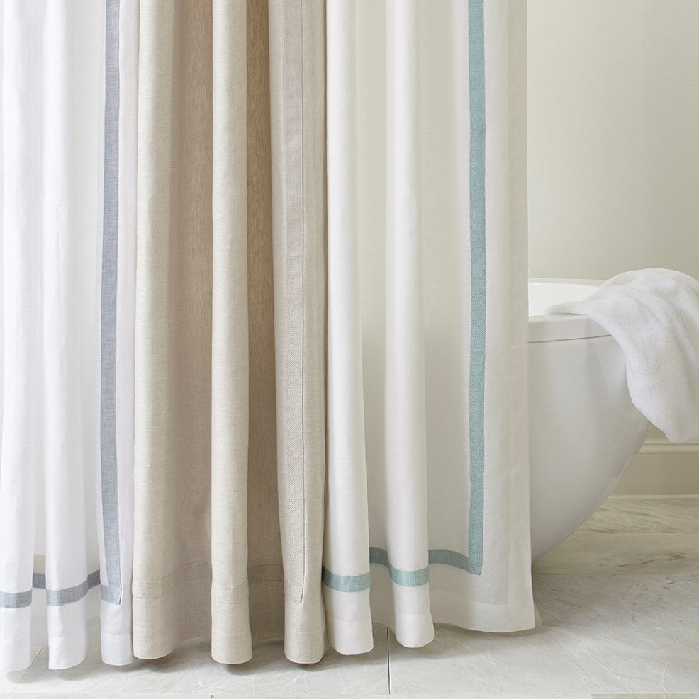Close-up of Fino shower curtain hem details in silver, linen, and aqua border colorways.