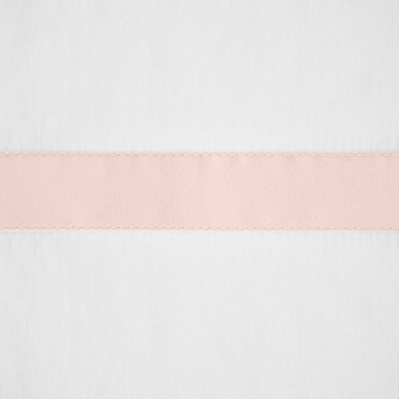 Close-up of blush satin border stripe with scalloped edge on white linen fabric.