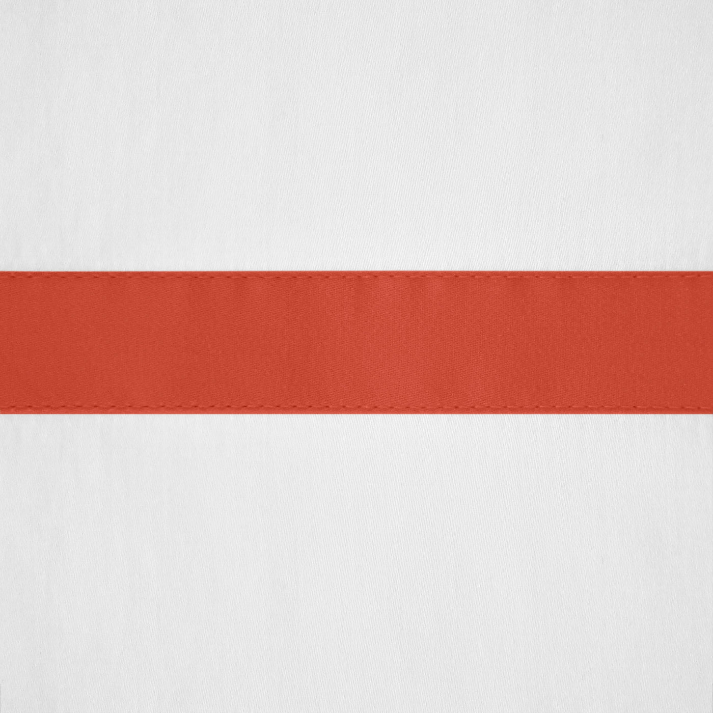 Close-up of white linen with a terracotta border band and stitched detail.