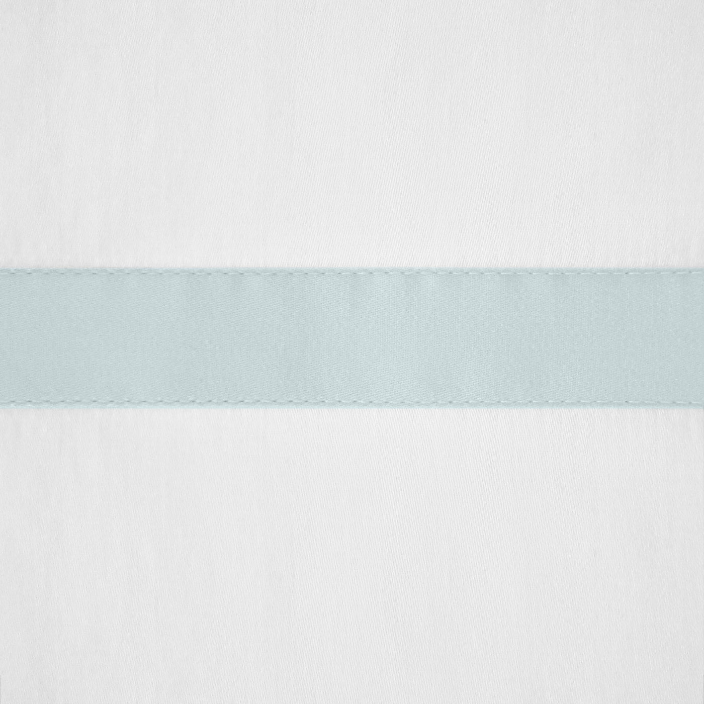 Close-up of a pale aqua satin band with picot edging on white linen fabric.