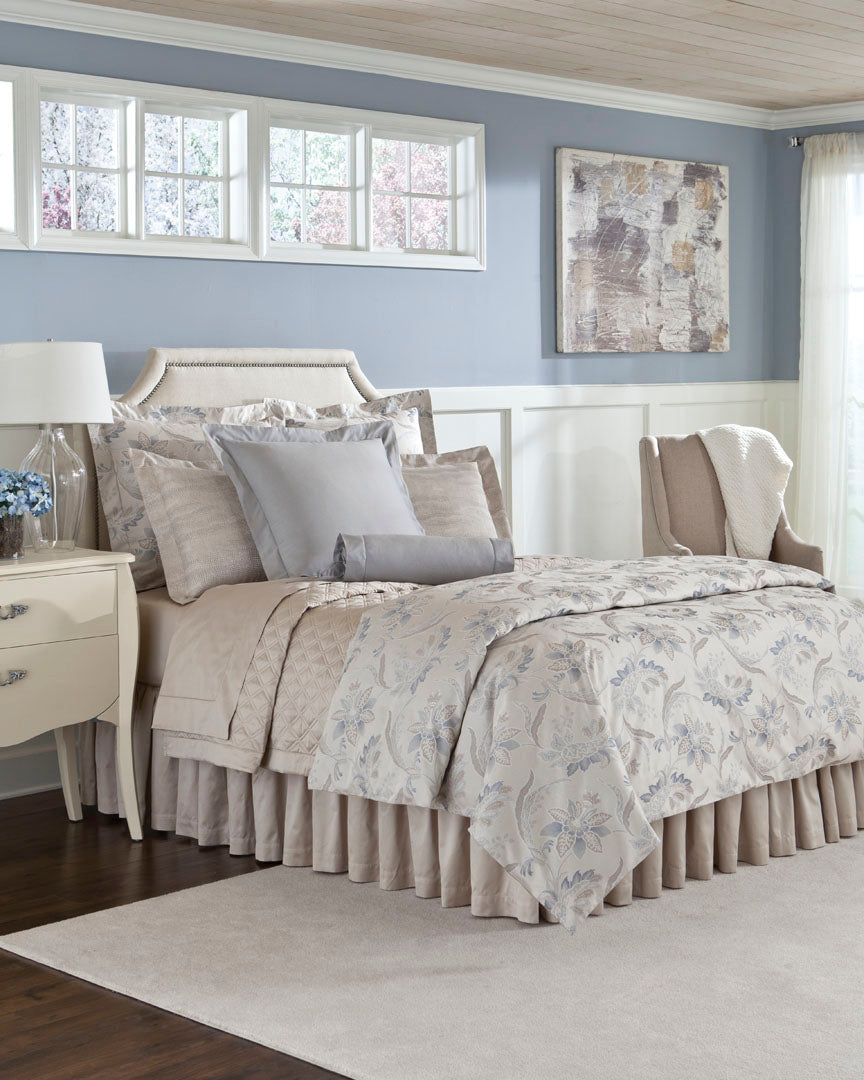 Close-up of Fiori pillowcase with soft blue floral print on ivory cotton.
