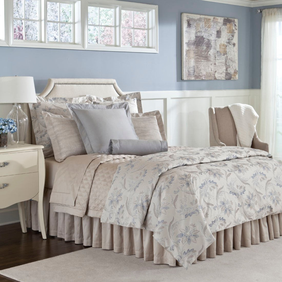Home Treasures Fiori bedding in ivory and blue floral print styled on a bed.