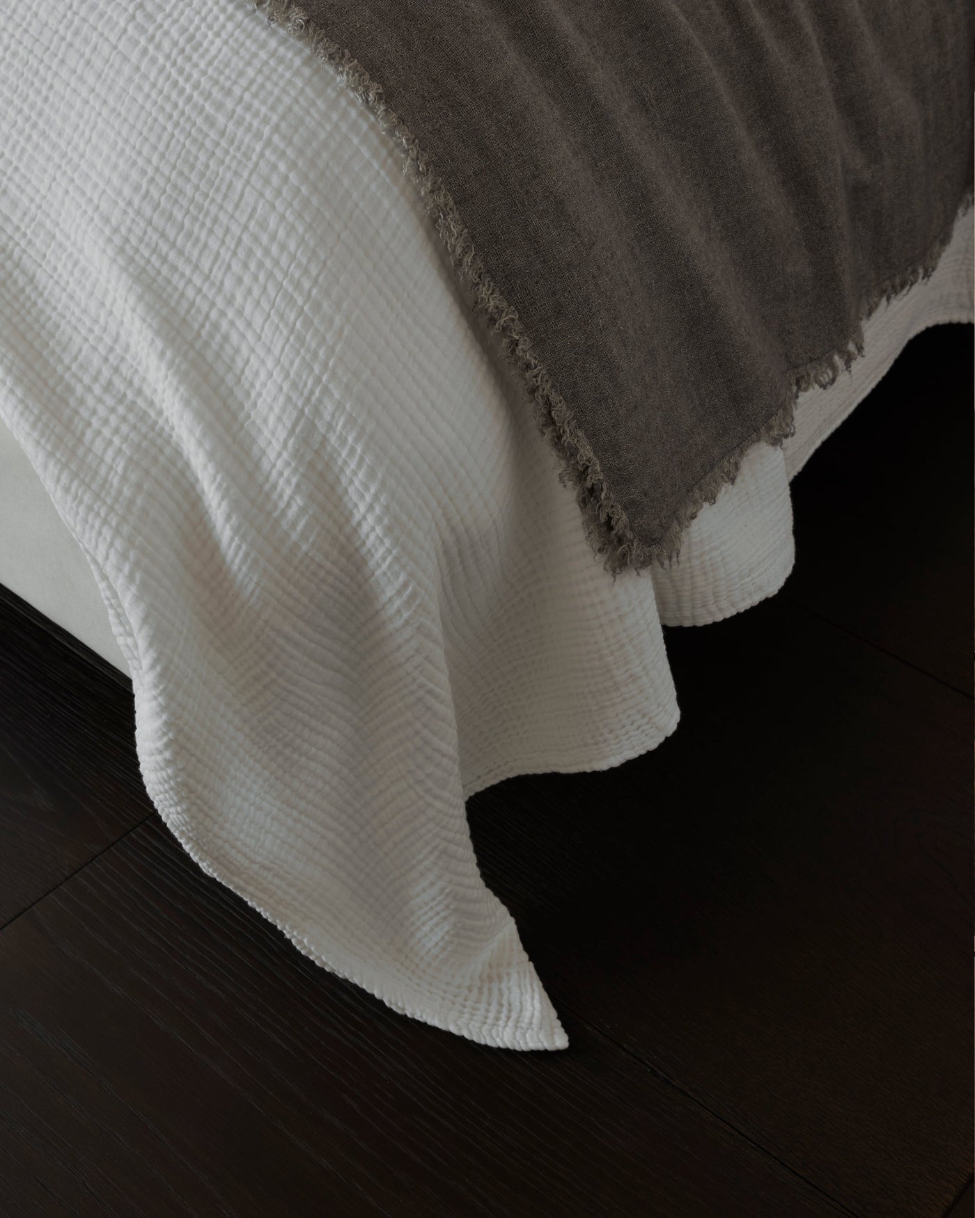 Society Limonta Free New ivory textured cotton bedcover draped over bed corner.