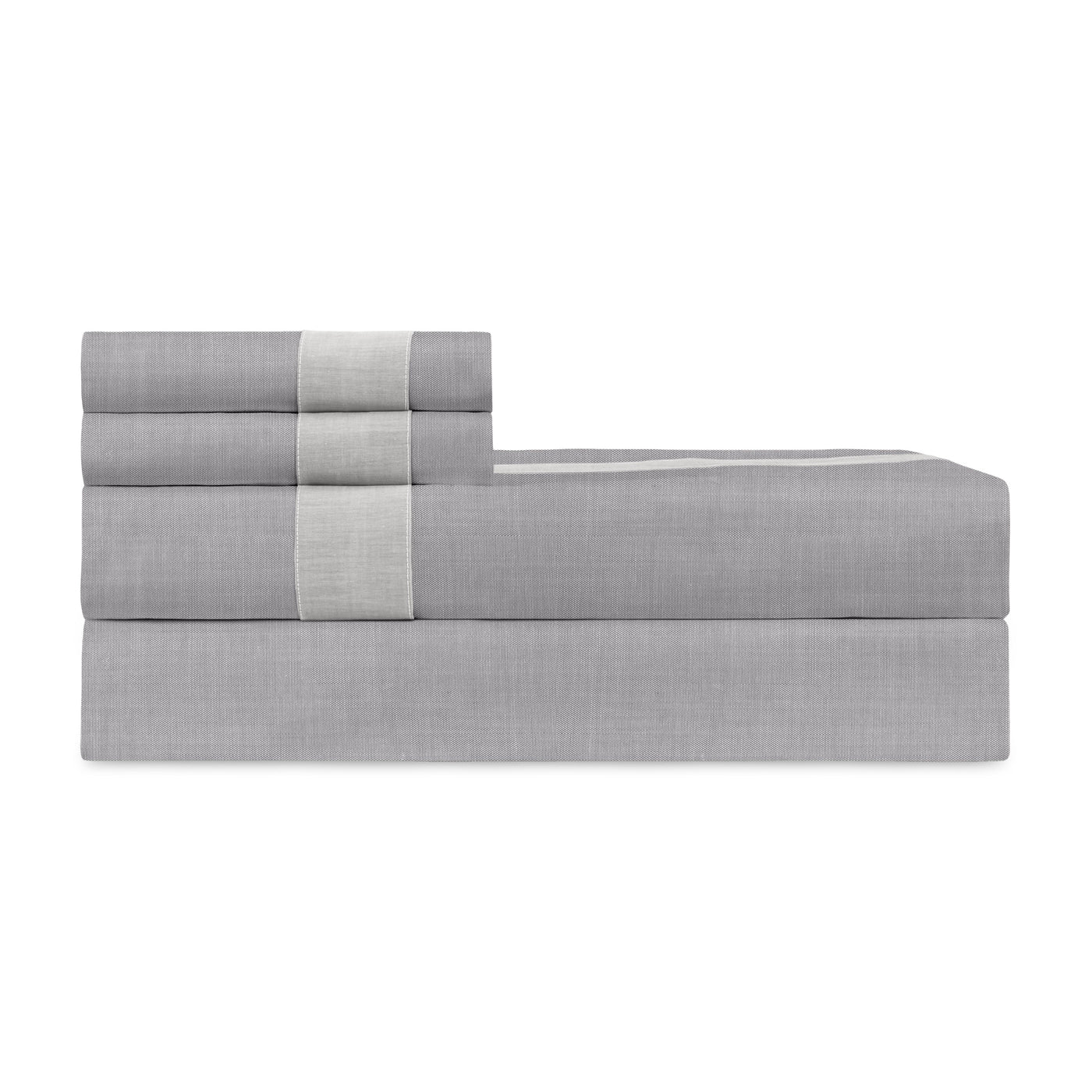Close-up of folded slate grey fitted sheet with ivory contrast band detail.