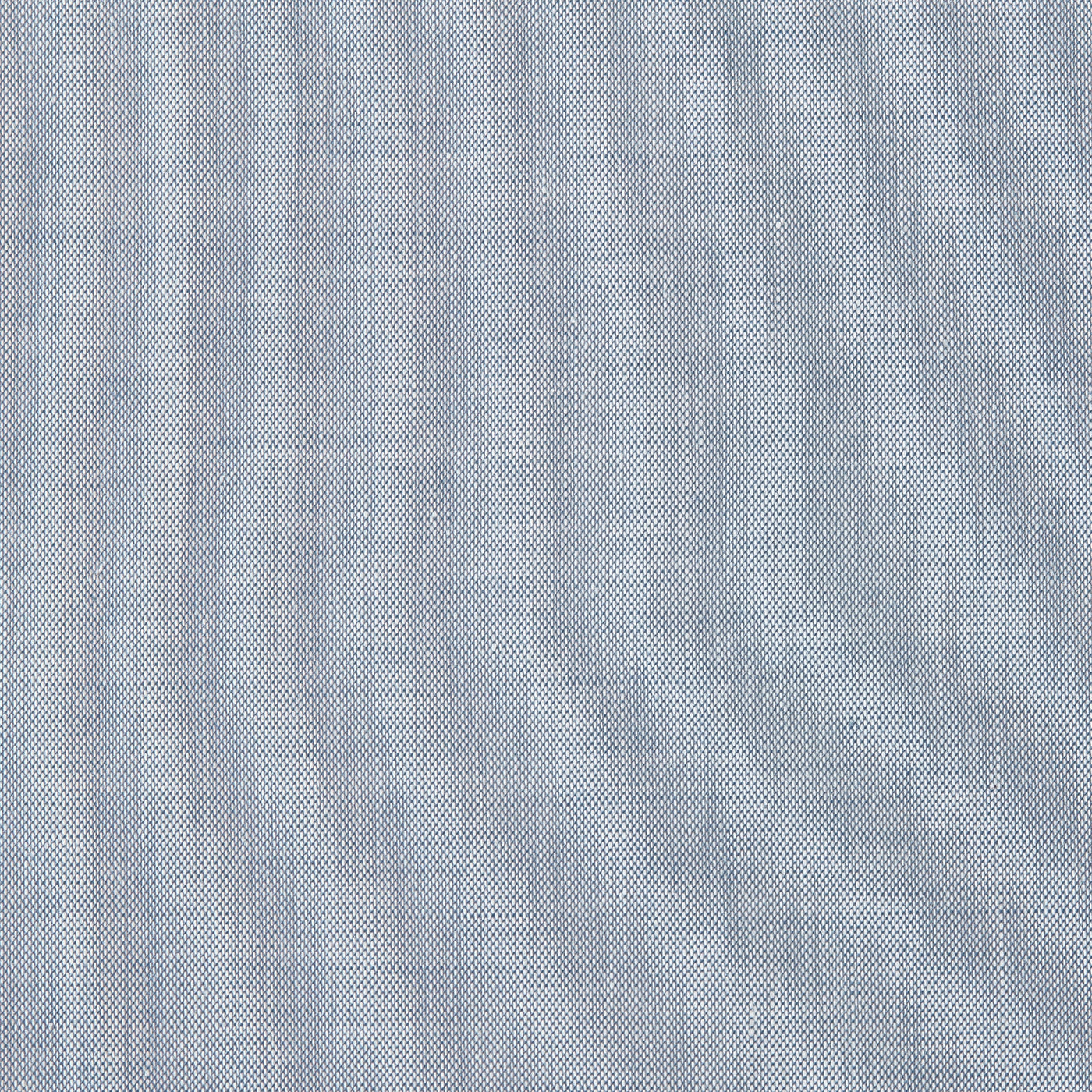 Close-up of Gaia quilted coverlet fabric in chambray blue linen weave texture.
