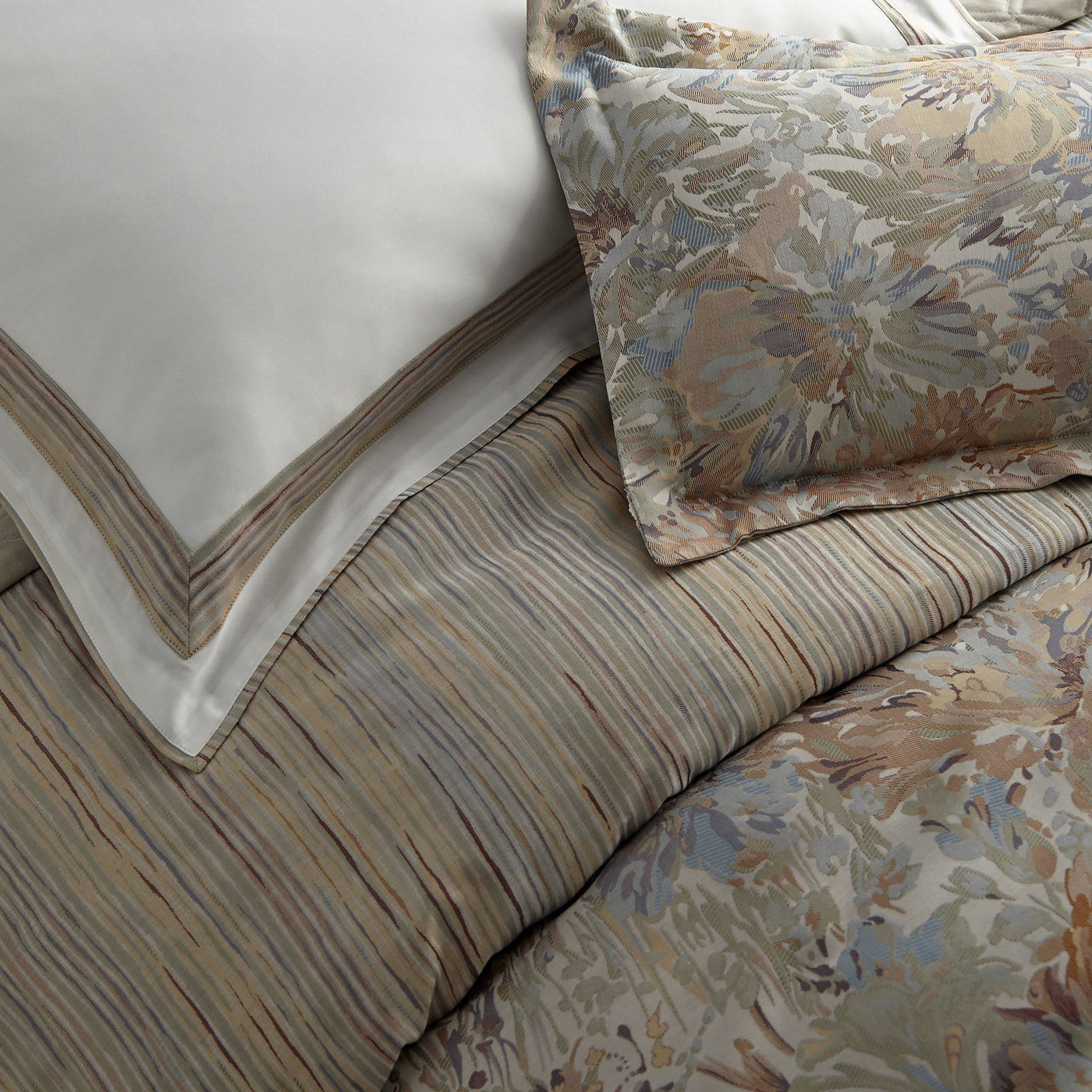 Close-up of Giverny duvet in taupe and slate blue floral jacquard with stripe reverse.