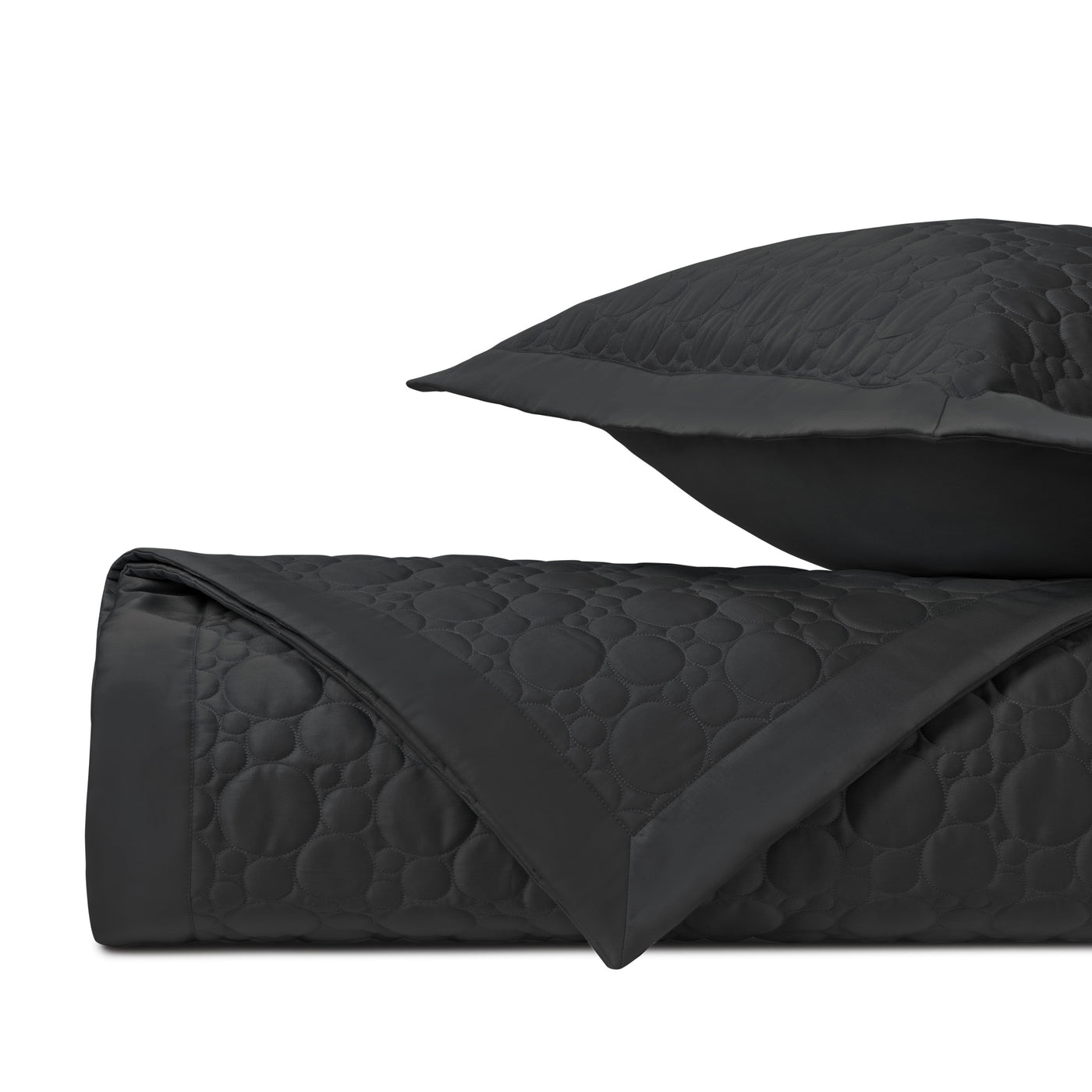 Close-up of Home Treasures Globe quilted texture in black with satin trim detail.