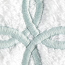 Close-up of seafoam Gordian Knot embroidery on white cotton terry.