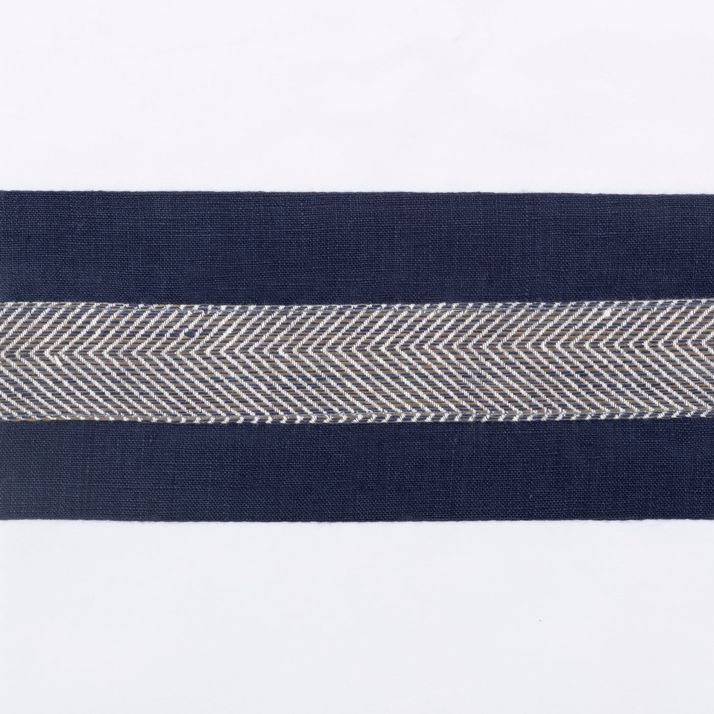Close-up of navy border with woven herringbone center stripe on white linen.