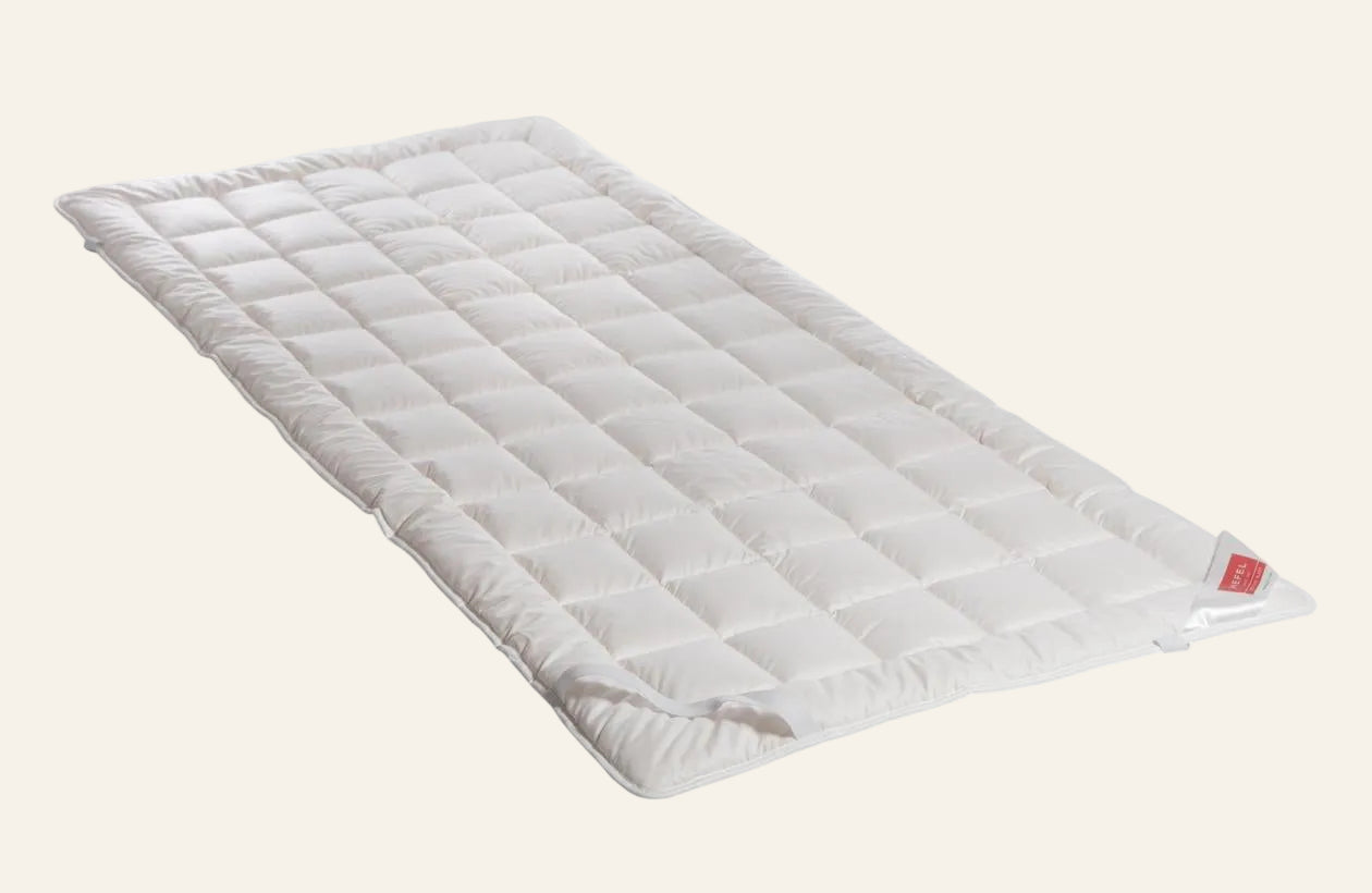 HEFEL Pure Wool mattress pad in white, displayed flat with quilted square pattern.