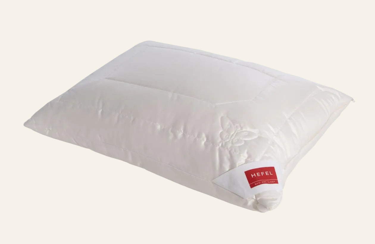 White pillow with a red label on a white background