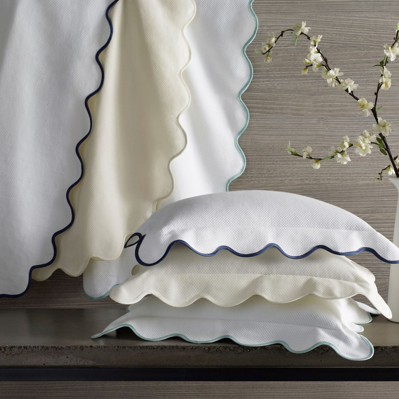 Home Treasures Honeycomb white pillow shams with scalloped navy and aqua trim.