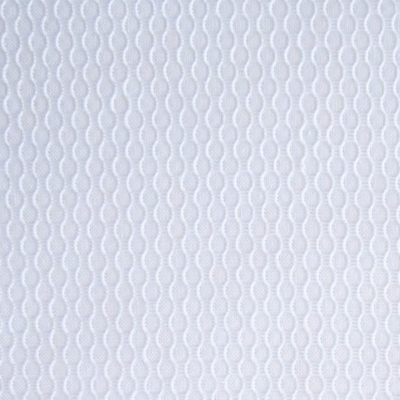 Close-up of Home Treasures Honeycomb white cotton texture with woven oval chain pattern.