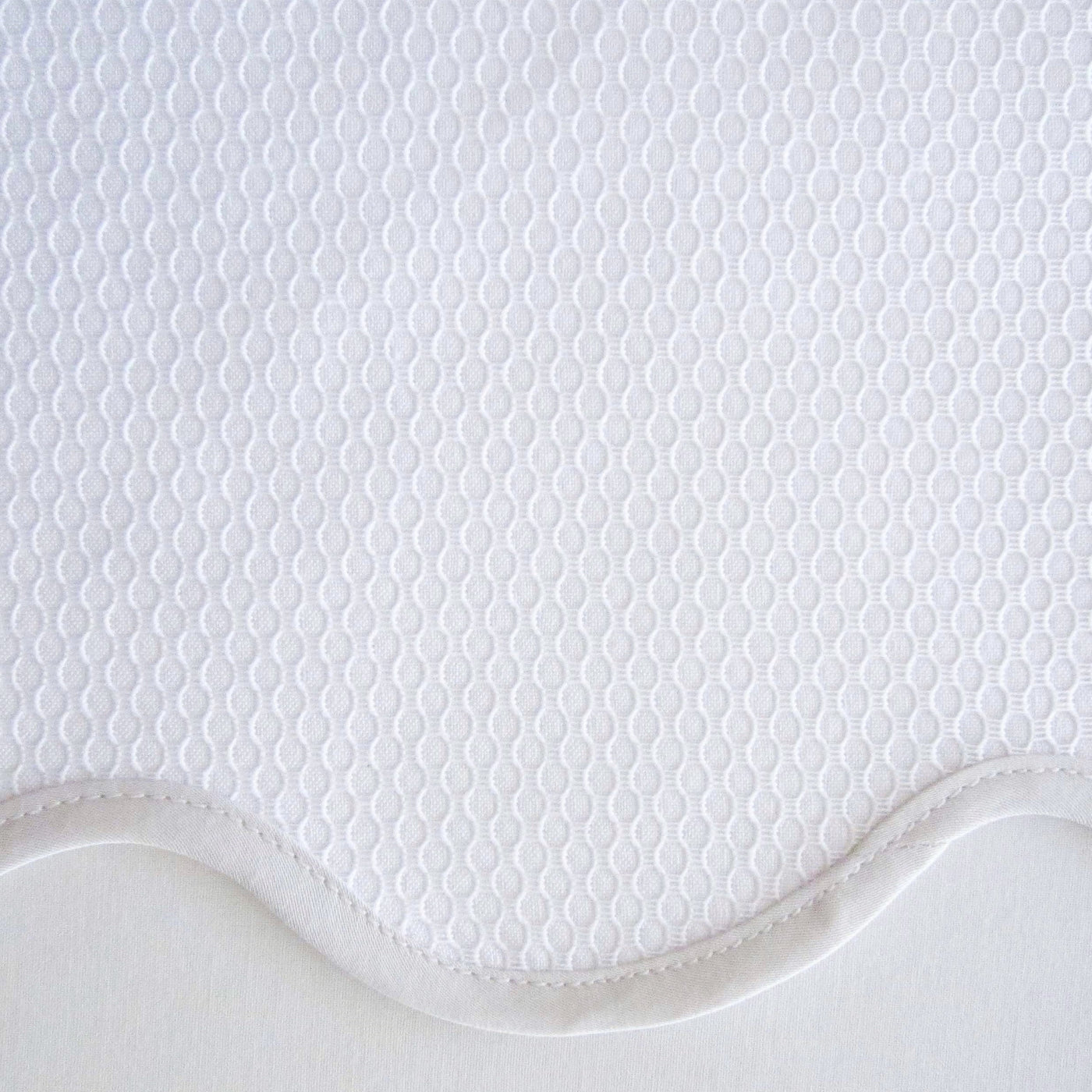 Close-up of white Honeycomb textured weave with scalloped border detail.