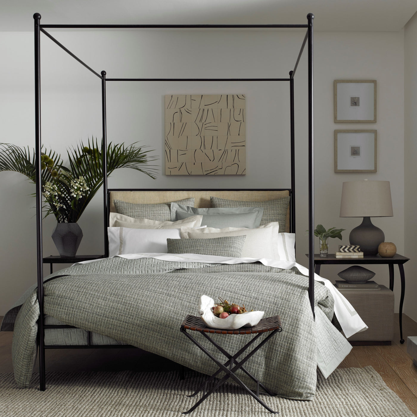 Home Treasures Jacqueline bedding in sage, styled on a black four-poster canopy bed.