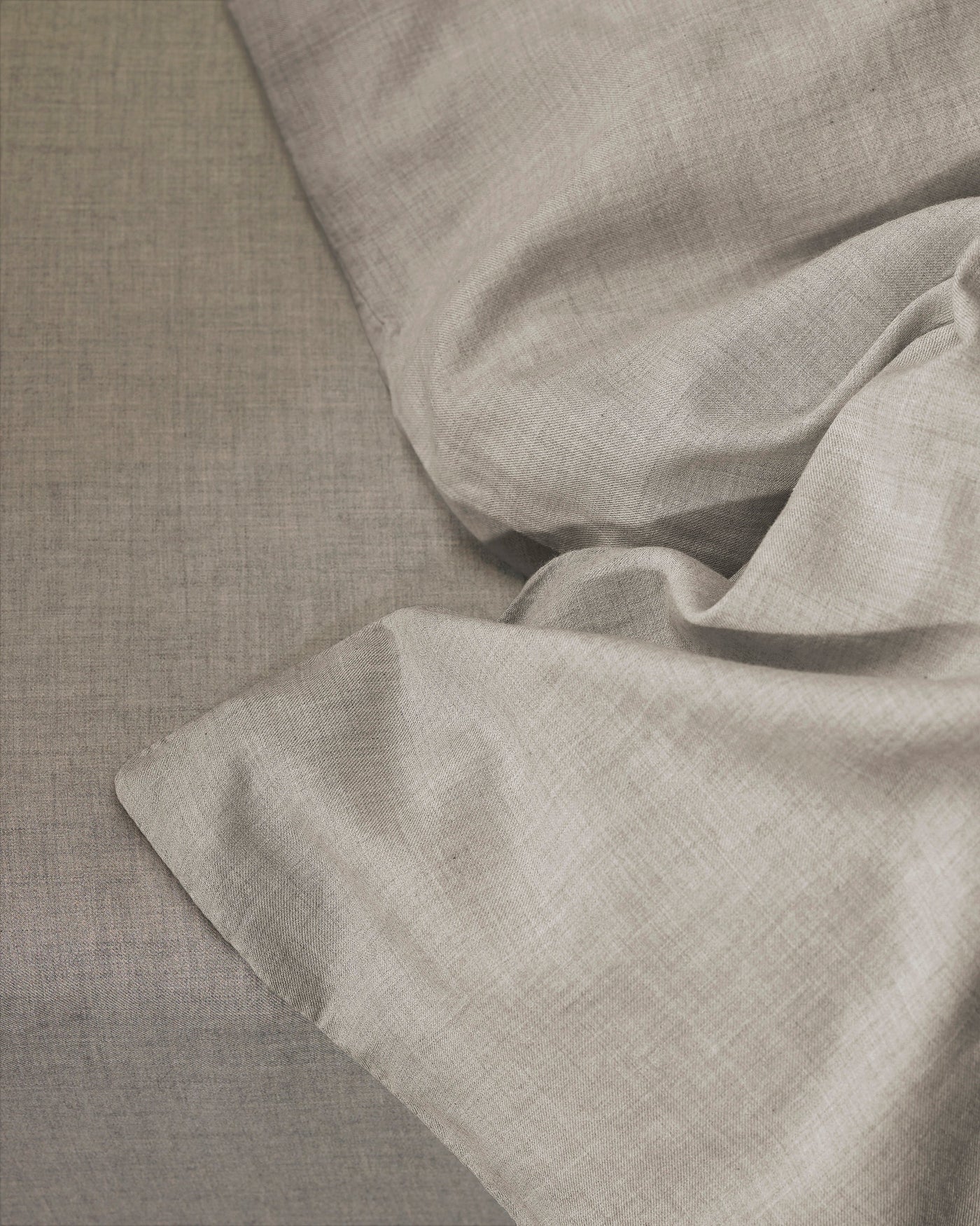 Close-up of Society Limonta Smir duvet cover in greige linen, showing relaxed drape and texture.