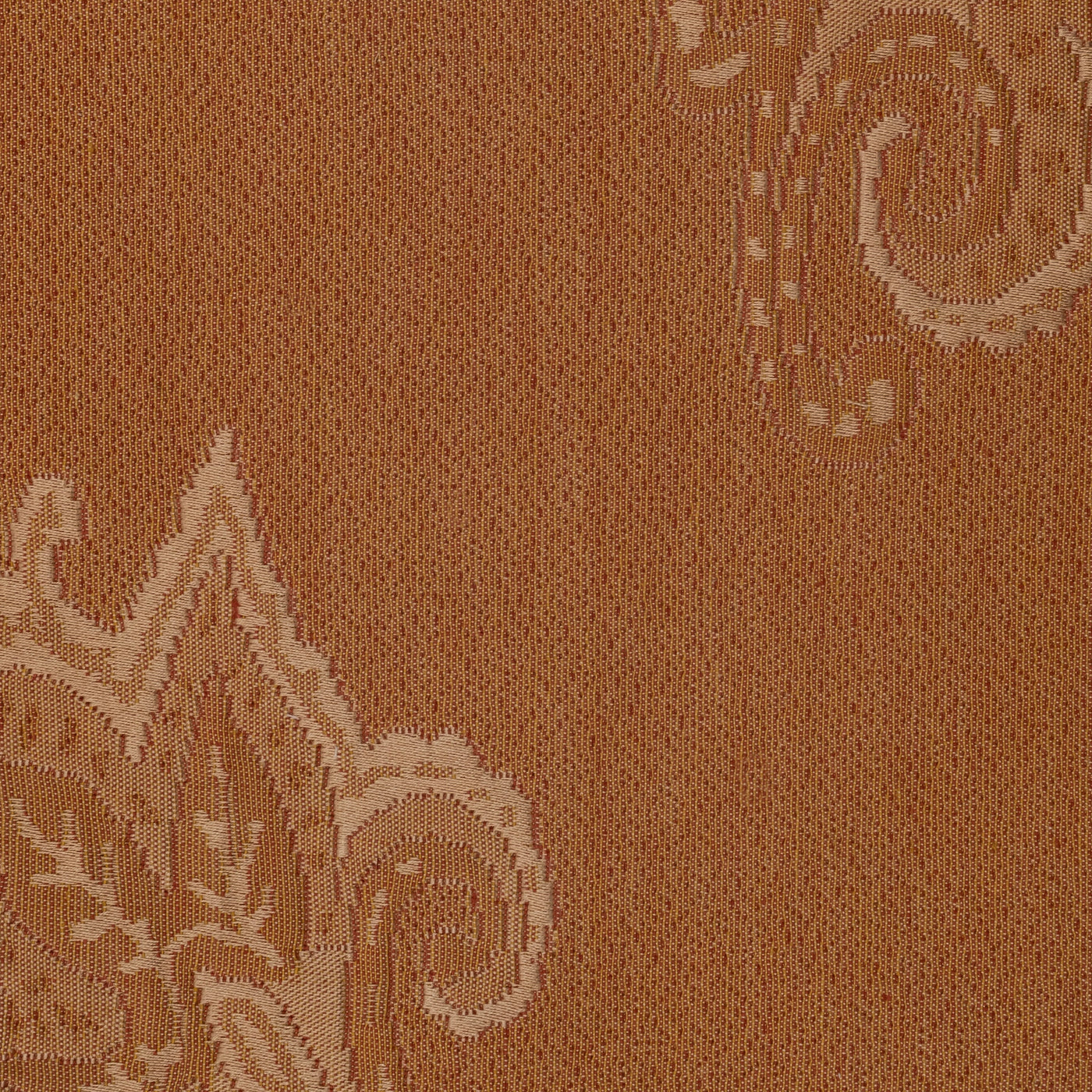 Close-up of Home Treasures Kashan woven damask pattern in amber and caramel tones.