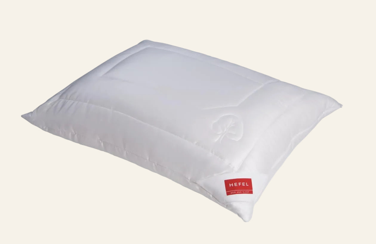 White pillow with a red label on a white background