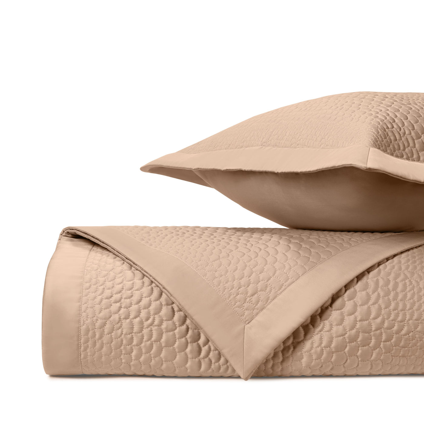 Close-up of Home Treasures Komodo quilted texture in warm camel with tonal circle pattern.