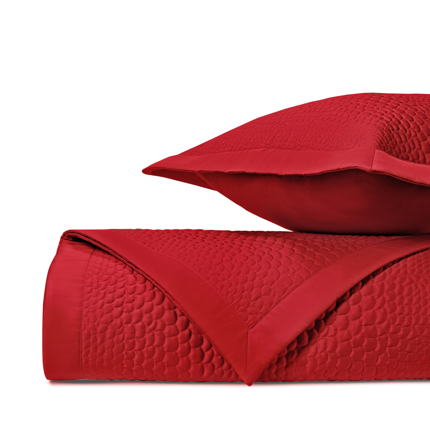 Close-up of crimson quilted satin with geometric honeycomb stitching pattern.