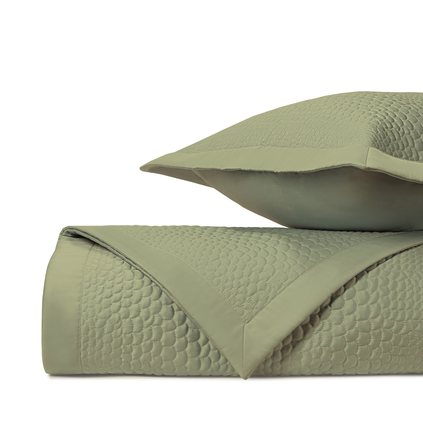 Close-up of Home Treasures Komodo quilted texture in sage green, folded with matching sham.