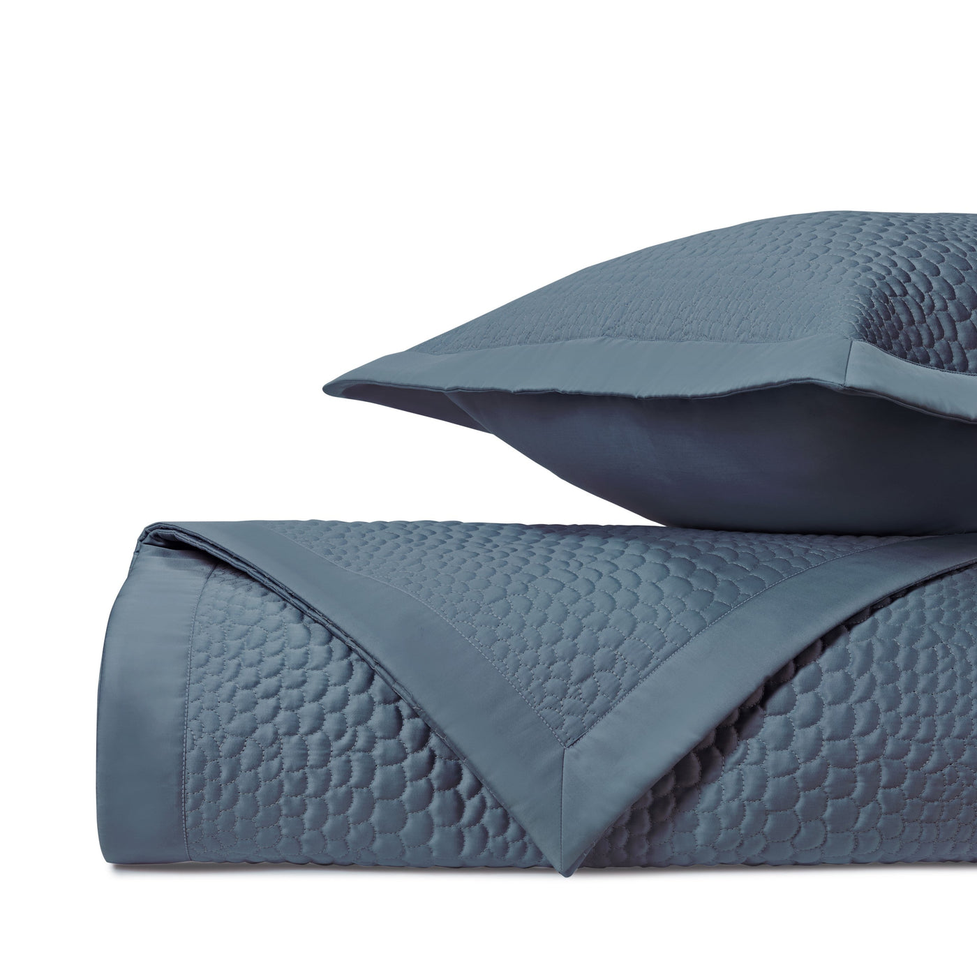 Close-up of Home Treasures Komodo quilted texture in slate blue with geometric stitching.