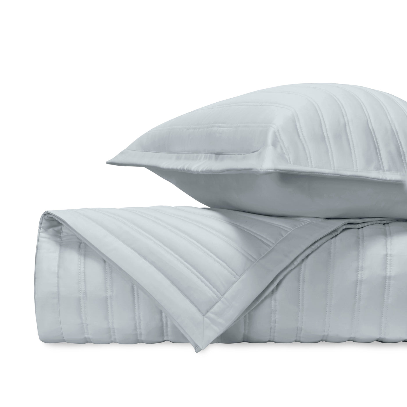 Close-up of L'Avenue quilted satin in mist blue with parallel channel stitching detail.
