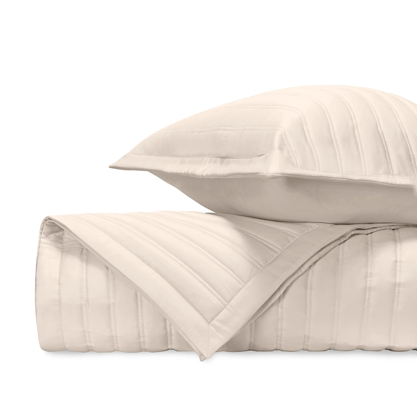 Close-up of ivory quilted cotton with parallel channel stitching detail.