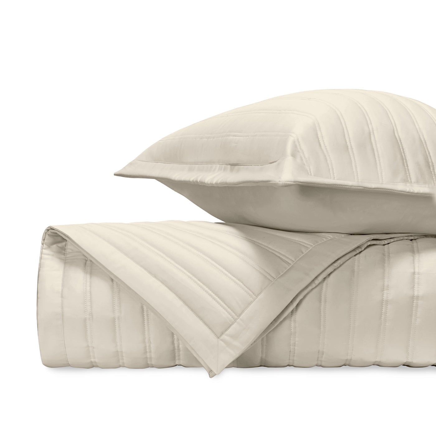 Close-up of ivory quilted cotton with parallel channel stitching detail.