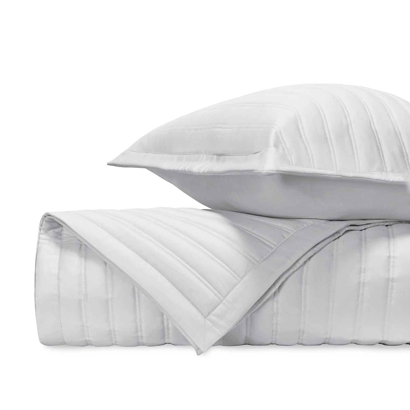 Close-up of white quilted cotton with parallel channel stitching detail.