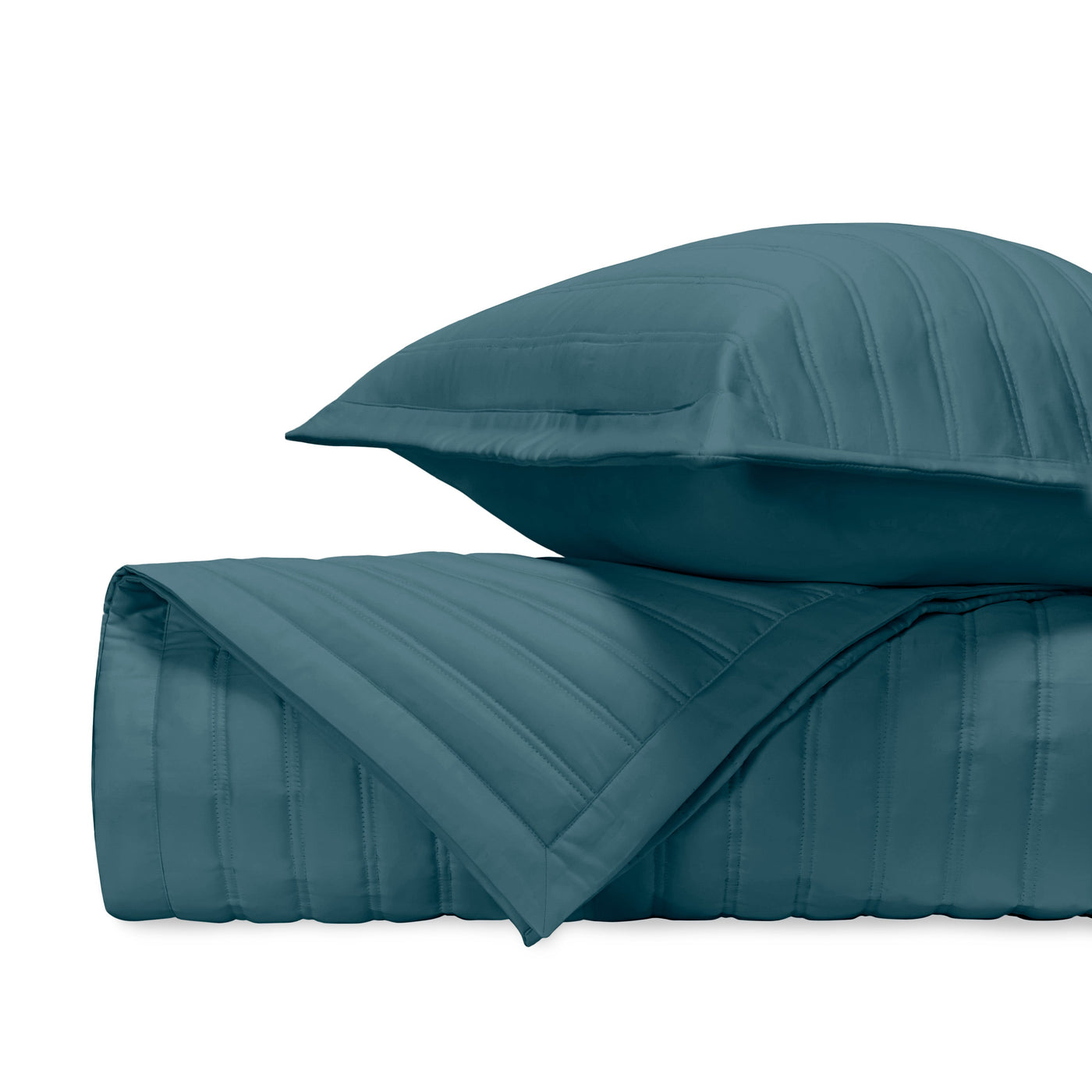 Teal quilted coverlet and sham showing parallel channel stitching detail.