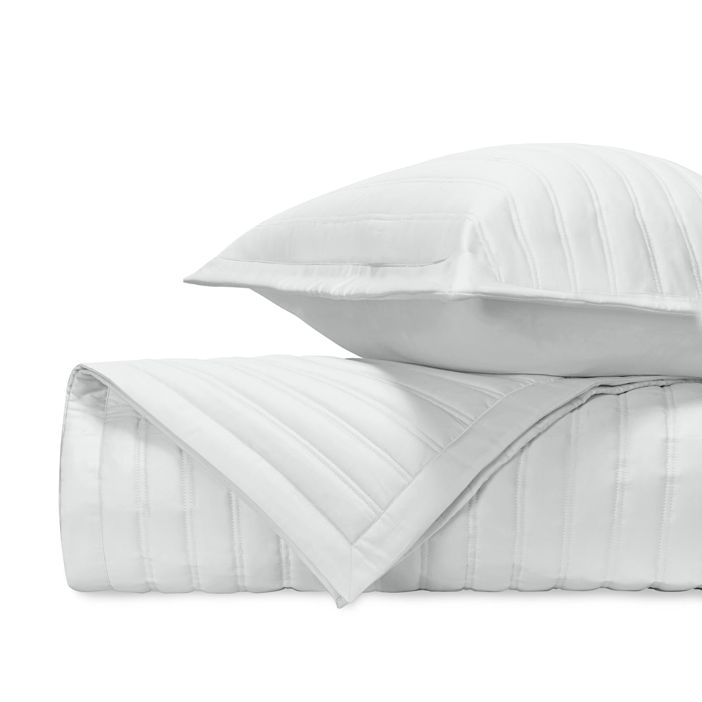 Close-up of white quilted cotton with parallel channel stitching detail.