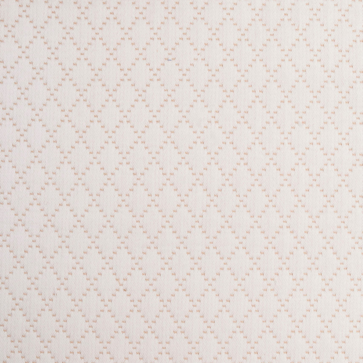 Close-up of ivory cotton coverlet with blush diamond lattice woven pattern.