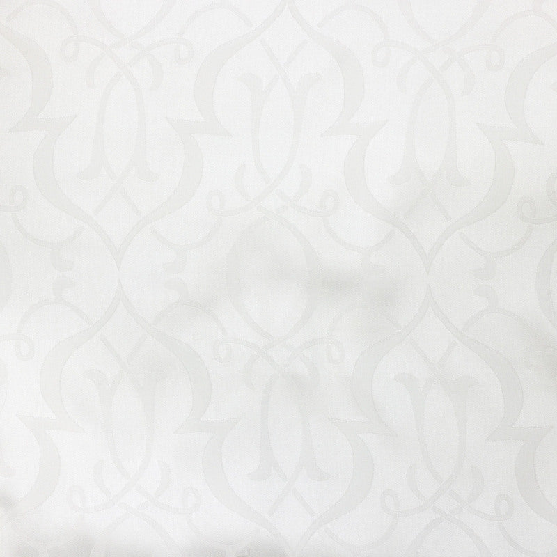Close-up of ivory damask woven pattern on Agadir bed skirt fabric.