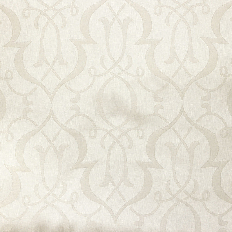 Close-up of Legna Agadir pillow fabric showing ivory damask-style woven pattern.