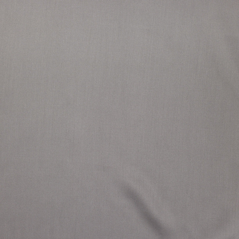 Close-up of silver-grey fabric with subtle sheen and soft drape at corner.
