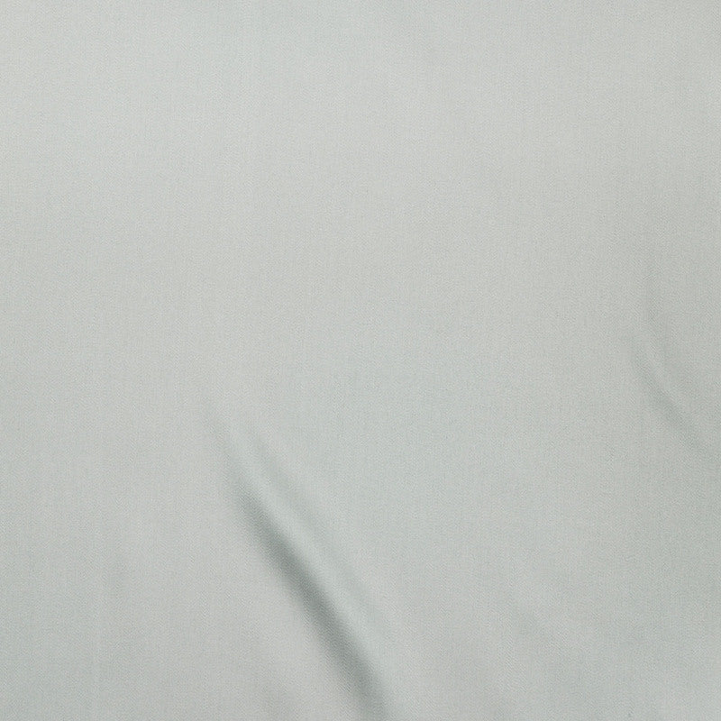 Close-up of pale sage Legna Classic decorative pillow fabric with subtle drape and soft sheen.