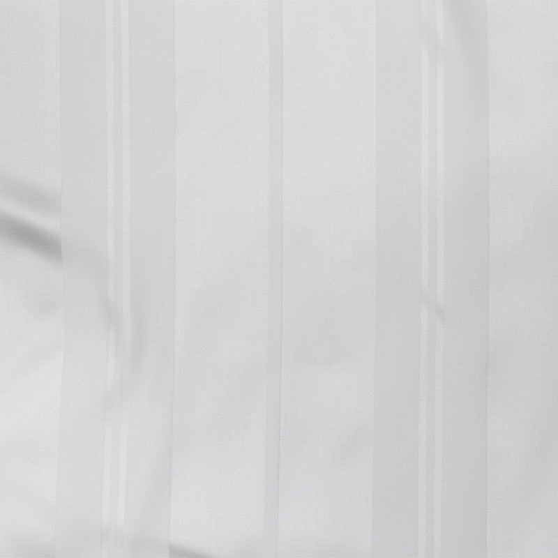 Close-up of white-on-white woven stripe fabric texture on Legna Lucca Stripe bedskirt.