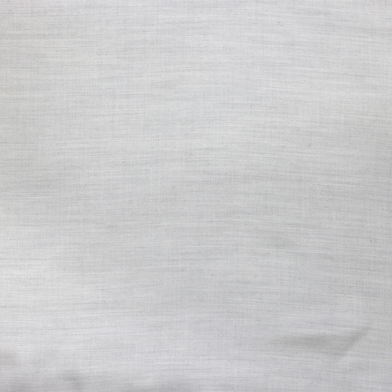 Close-up of Legna Pisa bedskirt fabric in pale silver-grey woven linen texture.
