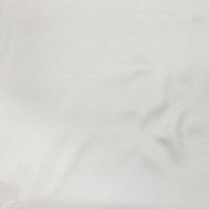 Close-up of ivory Legna Prieta flat sheet fabric showing subtle drape and sheen.