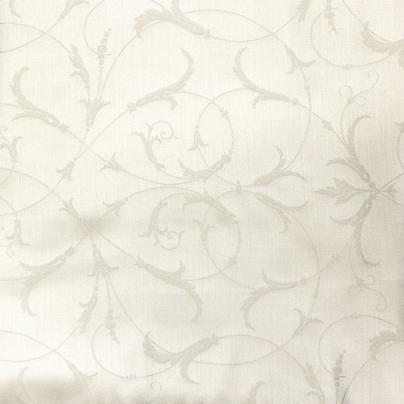 Close-up of ivory Legna Seville pillow fabric with tone-on-tone scrolling floral embroidery.