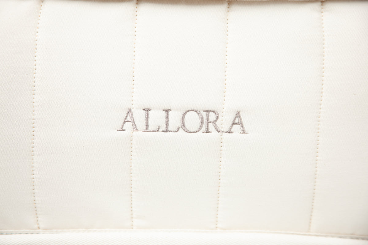 Close-up of ALLORA embroidered on the quilted side of the mattress