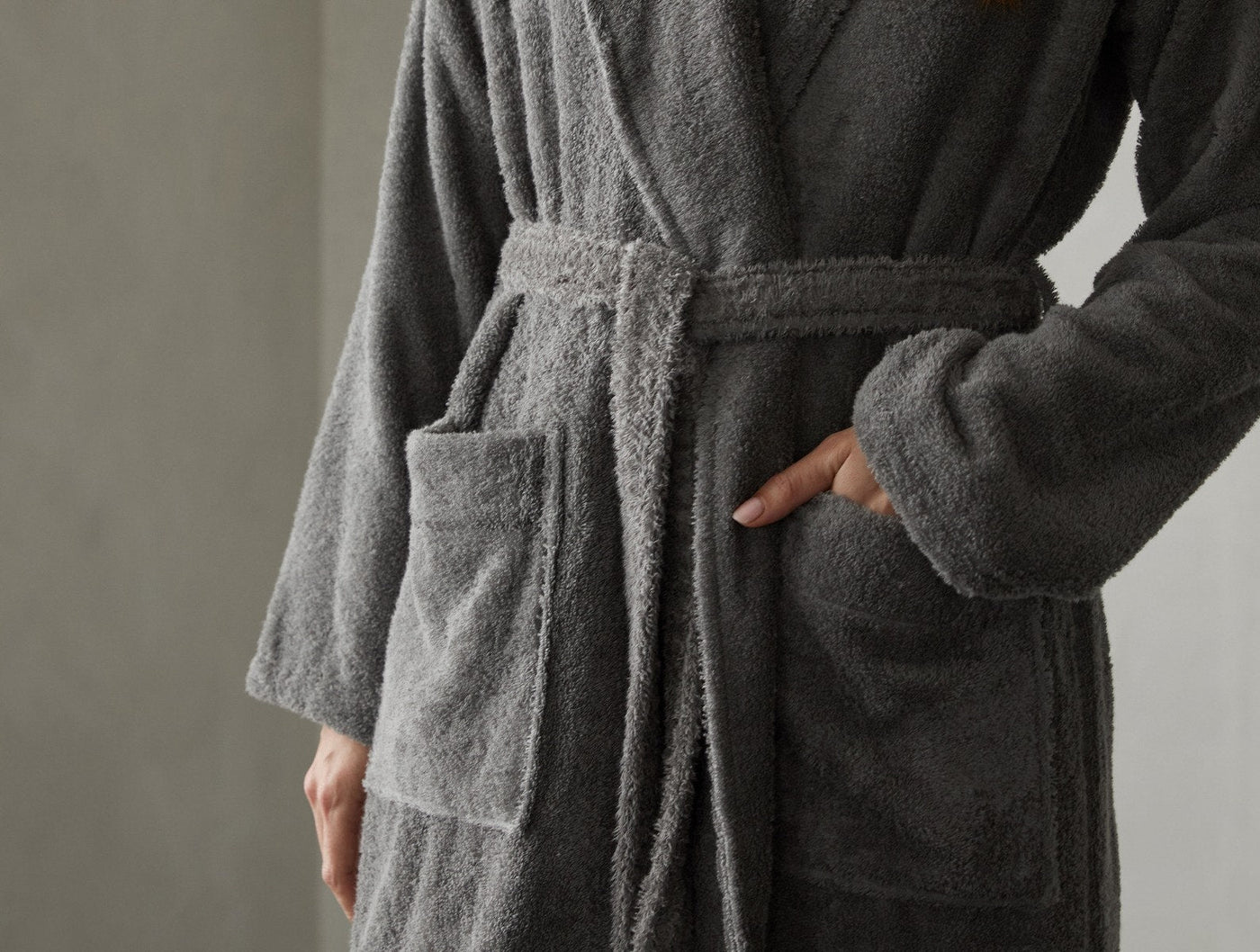 Close-up of Coyuchi Cloud Loom robe in slate, showing belted waist and patch pocket detail.