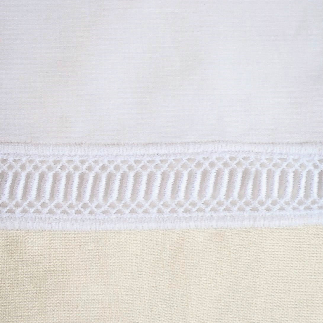 Close-up of white hemstitch trim detail on a Home Treasures Linea pillow sham.