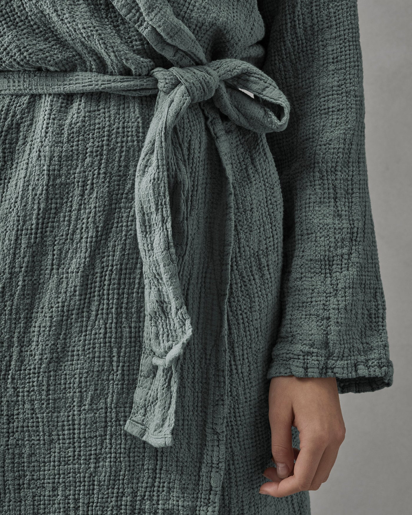 Close-up of Society Limonta Lipe New robe belt knotted at waist in sage green gauze cotton.