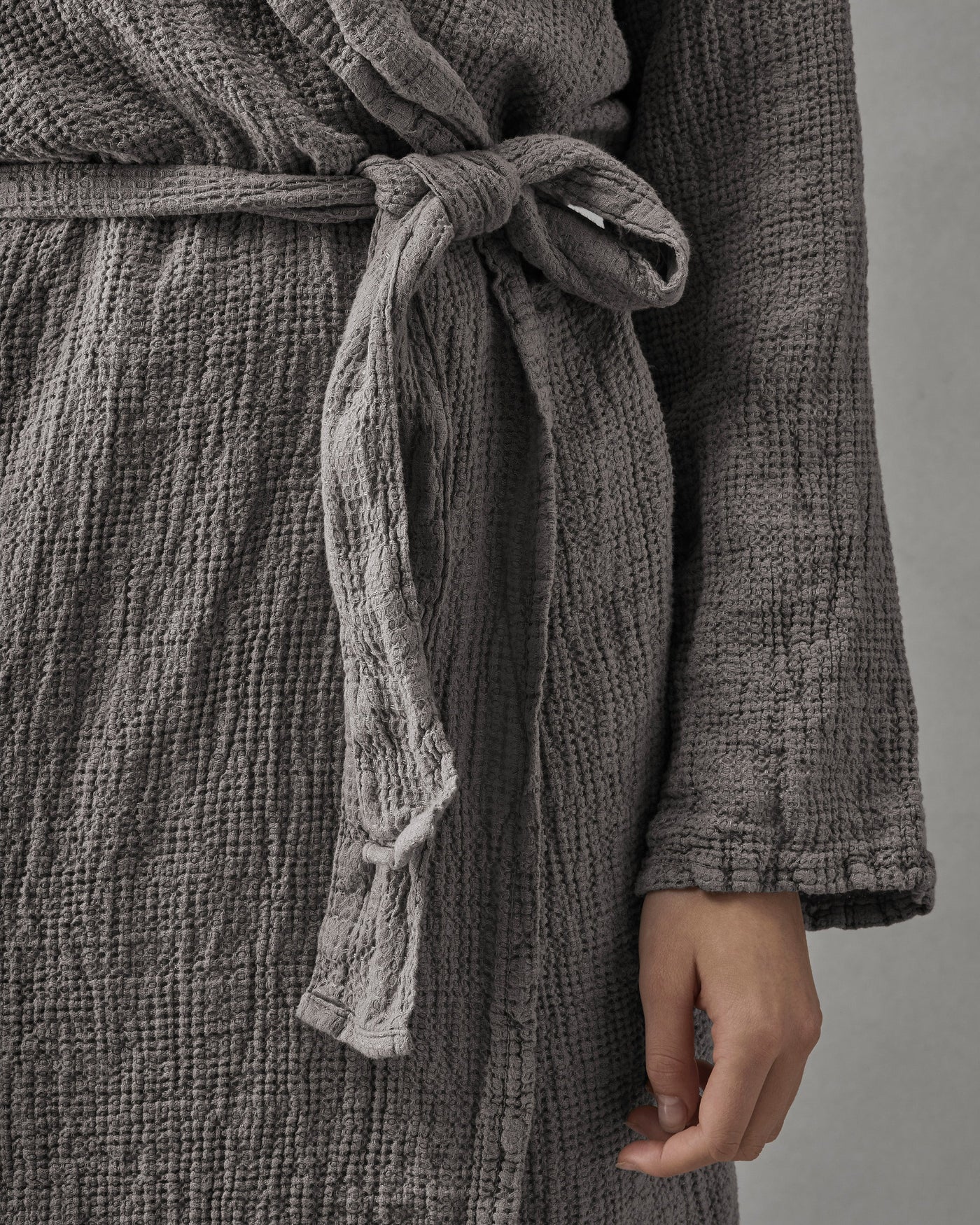 Close-up of Society Limonta Lipe New robe belt tied at waist in slate cotton gauze.