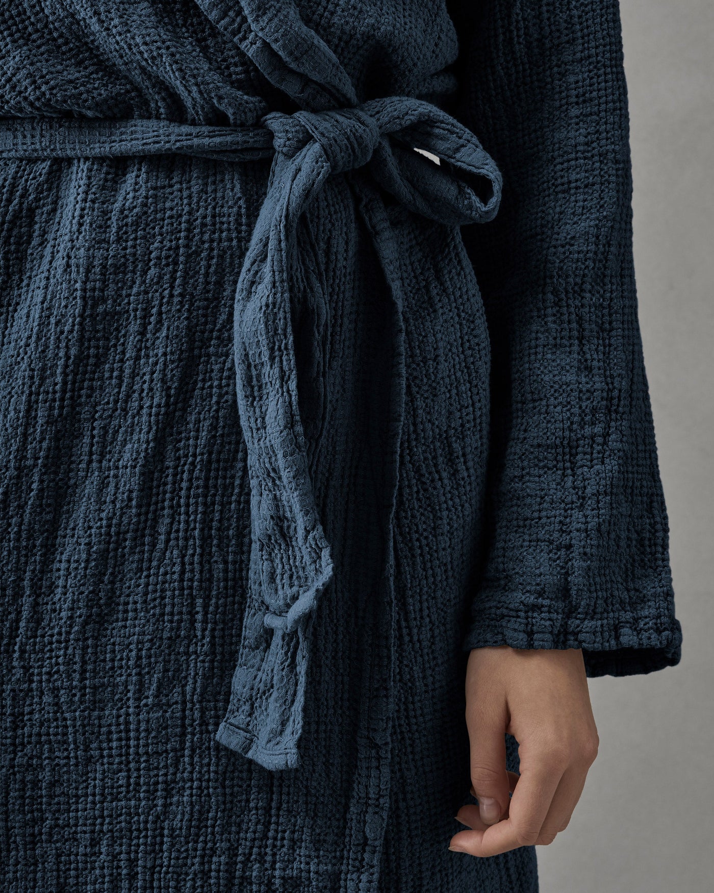 Close-up of Society Limonta Lipe New robe tie in midnight blue crinkled cotton muslin.